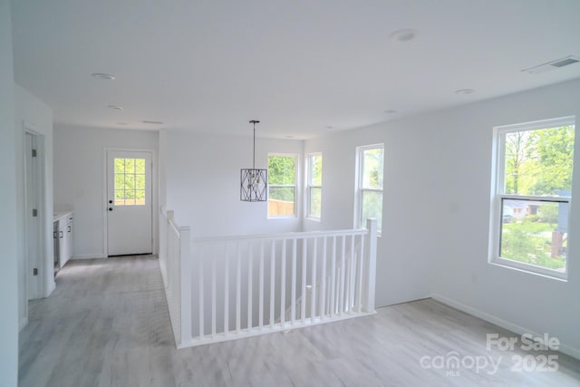 1413 Hateras Ave, Charlotte, NC 28216 - spare room with light wood finished floors, visible vents, baseboards, and a healthy amount of sunlight