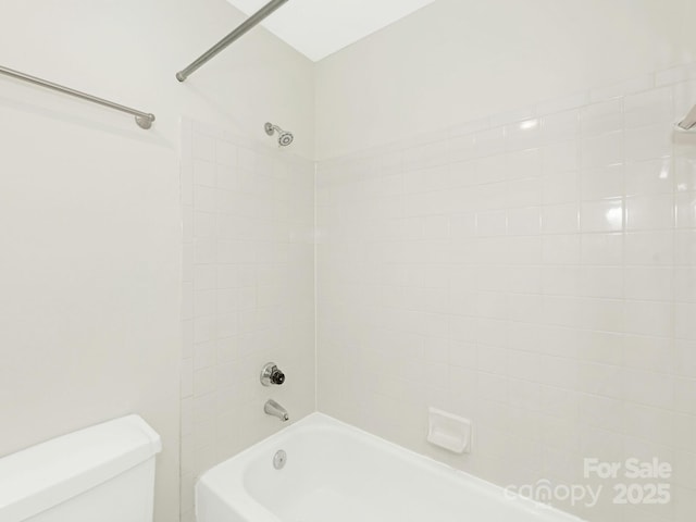 bathroom with shower / bathing tub combination and toilet