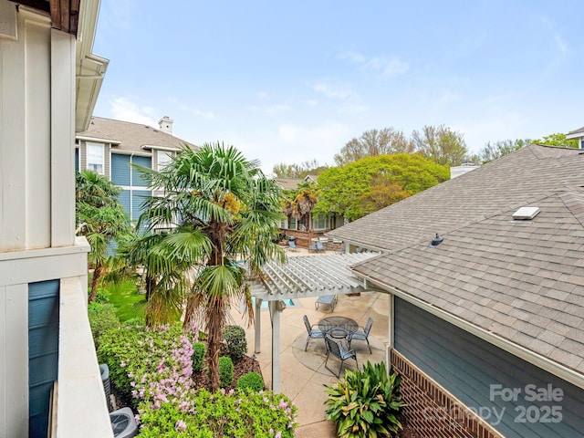 exterior space with roof with shingles