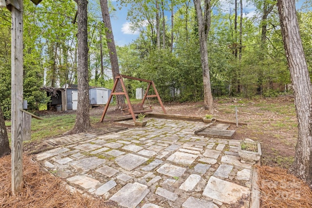 view of patio featuring an outdoor structure and a storage unit