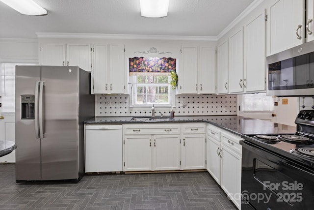 kitchen featuring a sink, ornamental molding, white cabinetry, and stainless steel appliances