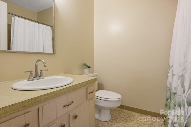 full bathroom with vanity, baseboards, tile patterned flooring, a shower with curtain, and toilet