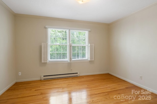 unfurnished room with baseboard heating, crown molding, light wood finished floors, and baseboards