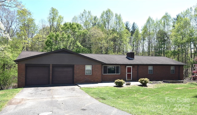 ranch-style house with a front yard, a shingled roof, an attached garage, brick siding, and driveway