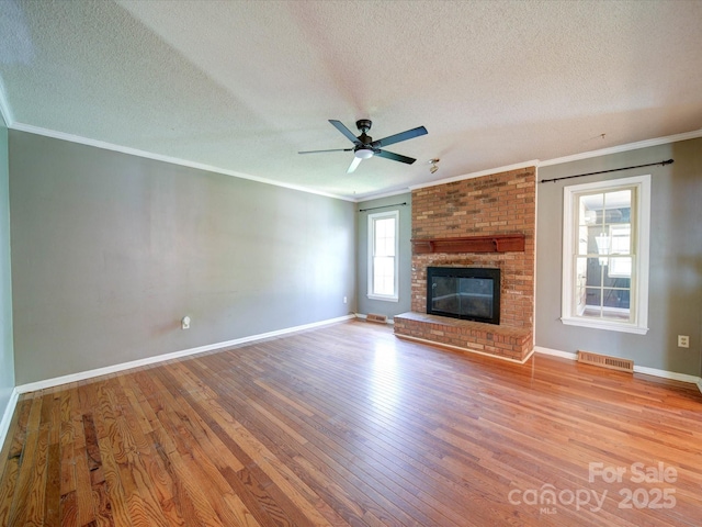 3530 Farm Lake Dr SW, Concord, NC 28027 - unfurnished living room with visible vents, baseboards, a textured ceiling, crown molding, and wood finished floors