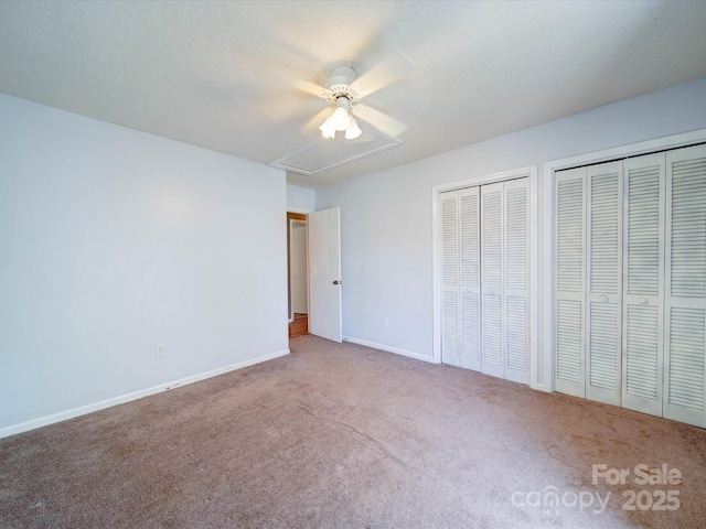 3530 Farm Lake Dr SW, Concord, NC 28027 - unfurnished bedroom featuring baseboards, ceiling fan, carpet, multiple closets, and attic access