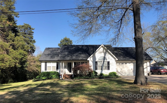 view of front of house with concrete driveway, a front yard, and a garage