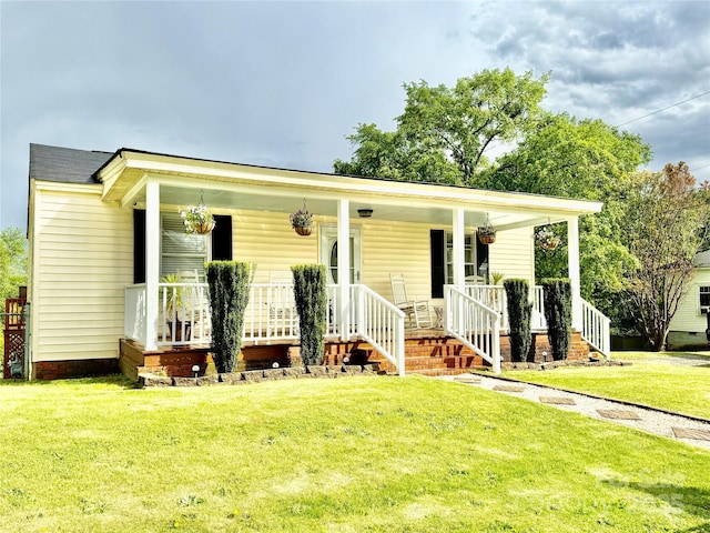 bungalow-style home with a front yard and covered porch