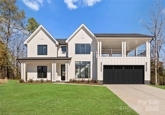13453 Portside Ln, Lancaster, SC 29720 - modern farmhouse style home with board and batten siding, a balcony, a front lawn, concrete driveway, and an attached garage