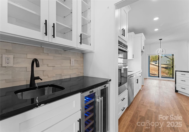 13453 Portside Ln, Lancaster, SC 29720 - kitchen featuring a sink, beverage cooler, stainless steel appliances, backsplash, and glass insert cabinets