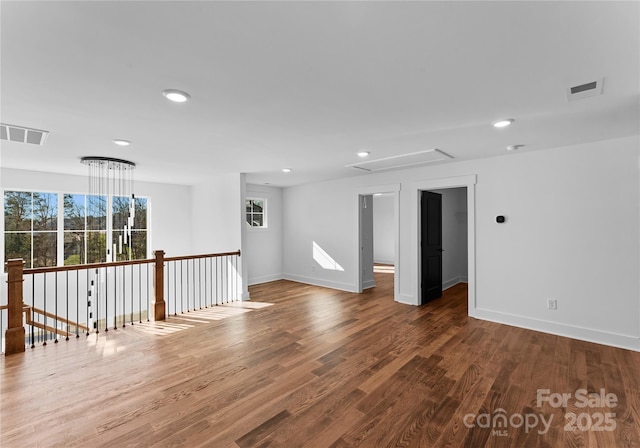 13453 Portside Ln, Lancaster, SC 29720 - empty room featuring baseboards, attic access, wood finished floors, and visible vents
