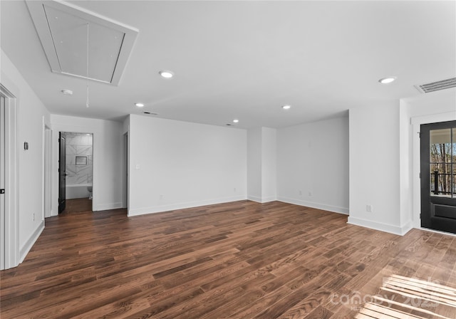 13453 Portside Ln, Lancaster, SC 29720 - unfurnished living room with dark wood-style flooring, attic access, recessed lighting, baseboards, and visible vents
