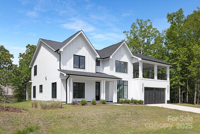 13453 Portside Ln, Lancaster, SC 29720 - modern farmhouse with a front yard, roof with shingles, board and batten siding, an attached garage, and driveway