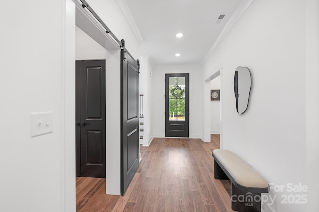 13453 Portside Ln, Lancaster, SC 29720 - hallway with ornamental molding, wood finished floors, baseboards, recessed lighting, and a barn door