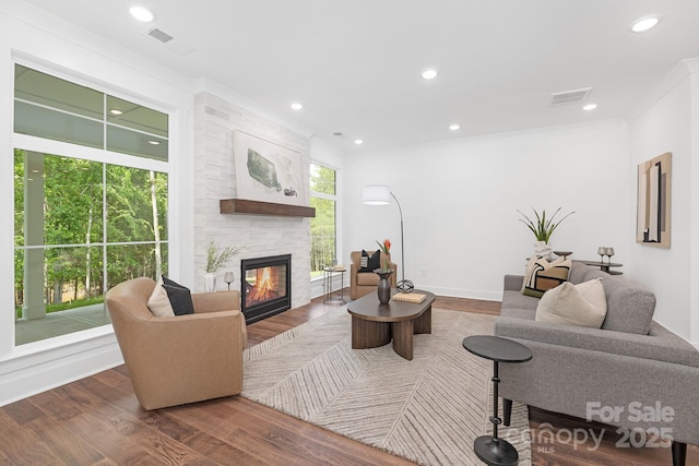 13453 Portside Ln, Lancaster, SC 29720 - living area featuring visible vents, ornamental molding, wood finished floors, and a fireplace
