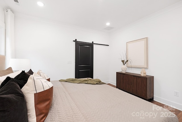 13453 Portside Ln, Lancaster, SC 29720 - bedroom with baseboards, ornamental molding, a barn door, and wood finished floors