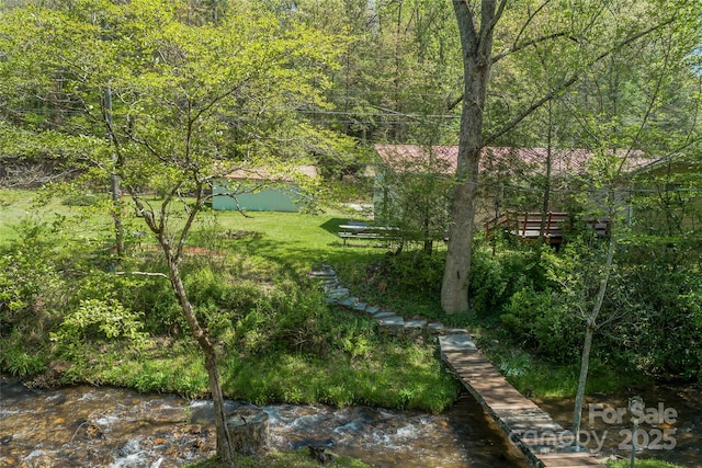 view of yard with a forest view