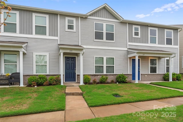 221 Century Dr, Salisbury, NC 28147 - view of property featuring board and batten siding, a front lawn, and brick siding