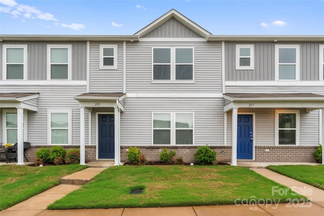 221 Century Dr, Salisbury, NC 28147 - multi unit property featuring board and batten siding, a front yard, and brick siding
