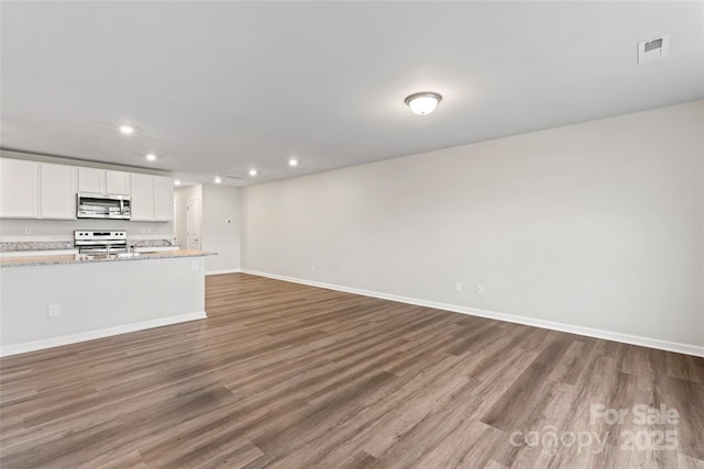 221 Century Dr, Salisbury, NC 28147 - unfurnished living room with recessed lighting, visible vents, baseboards, and wood finished floors