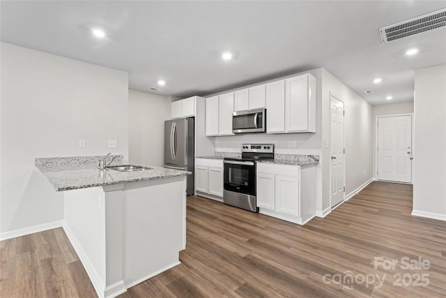 221 Century Dr, Salisbury, NC 28147 - kitchen featuring baseboards, dark wood-style floors, visible vents, stainless steel appliances, and a sink