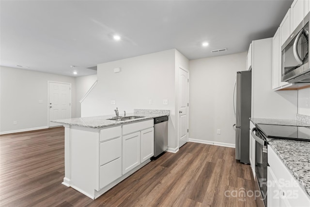 221 Century Dr, Salisbury, NC 28147 - kitchen featuring a peninsula, visible vents, appliances with stainless steel finishes, dark wood-style flooring, and a sink