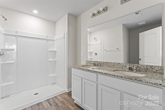 221 Century Dr, Salisbury, NC 28147 - bathroom featuring a walk in shower, a sink, and wood finished floors