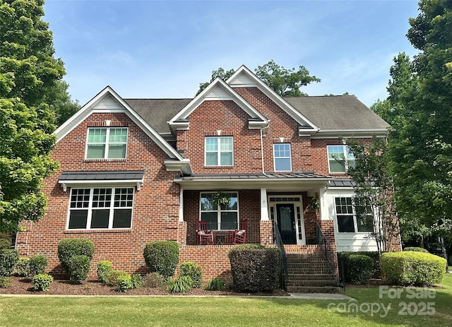 4711 Pearmain Dr, Waxhaw, NC 28173 - view of front of property with covered porch, brick siding, a standing seam roof, and a front yard