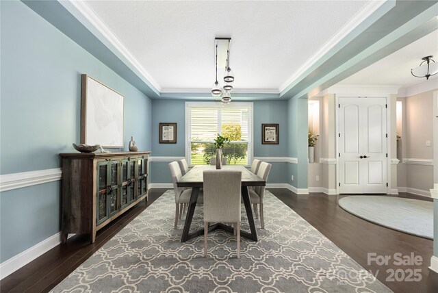 12942 Blakemore Ave, Huntersville, NC 28078 - dining space featuring baseboards, wood finished floors, a raised ceiling, and crown molding