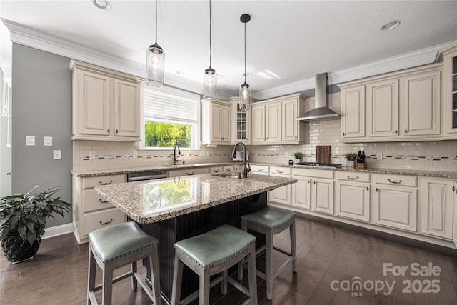 12942 Blakemore Ave, Huntersville, NC 28078 - kitchen featuring crown molding, wall chimney exhaust hood, appliances with stainless steel finishes, and a kitchen breakfast bar