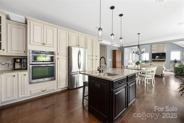 12942 Blakemore Ave, Huntersville, NC 28078 - kitchen featuring open floor plan, cream cabinetry, appliances with stainless steel finishes, and a sink