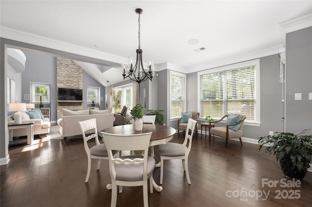 12942 Blakemore Ave, Huntersville, NC 28078 - dining space with dark wood finished floors, an inviting chandelier, ornamental molding, and baseboards