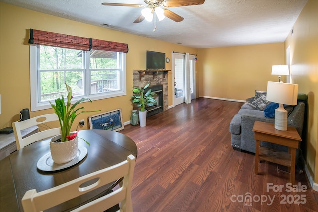 living room with baseboards, a wealth of natural light, dark wood finished floors, and ceiling fan