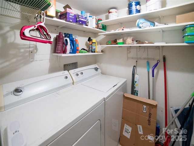 laundry area featuring washing machine and clothes dryer and laundry area