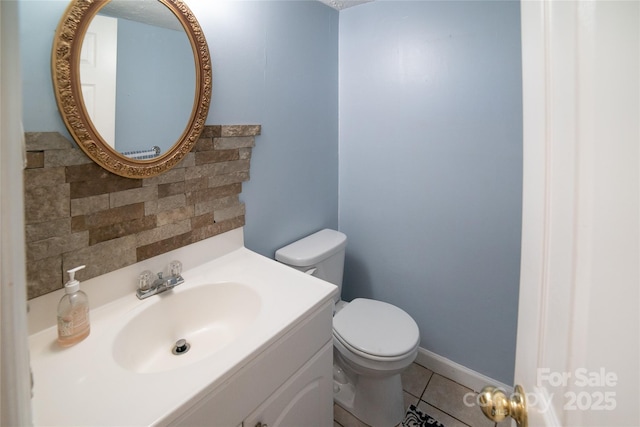 half bathroom with toilet, backsplash, tile patterned flooring, and vanity