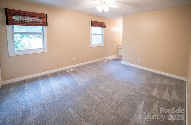 empty room featuring a ceiling fan, carpet, and baseboards