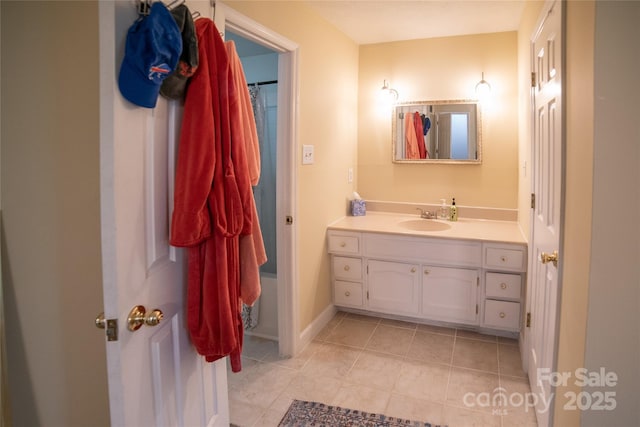 bathroom featuring vanity, baseboards, and tile patterned flooring