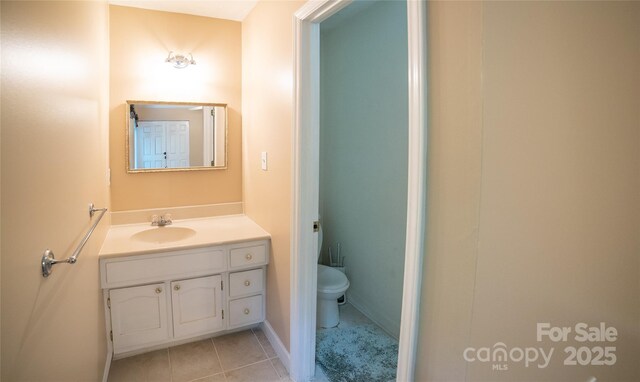 bathroom featuring vanity, toilet, and tile patterned floors