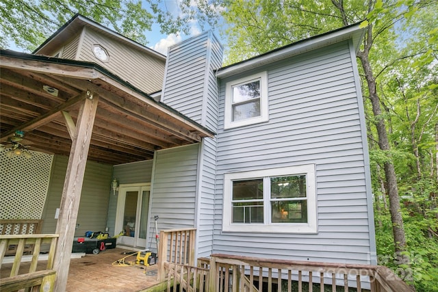 rear view of house with a wooden deck and a chimney