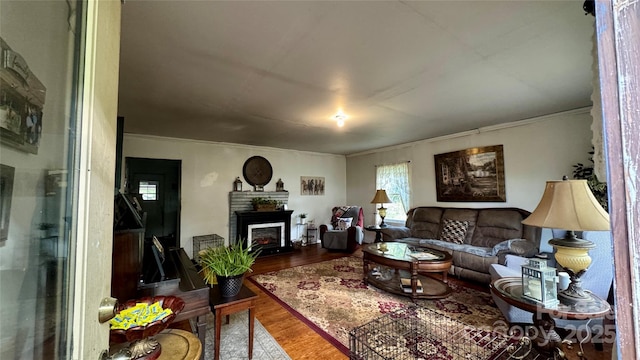 2118 Polkville Rd, Shelby, NC 28150 - living room with wood finished floors, ornamental molding, and a warm lit fireplace