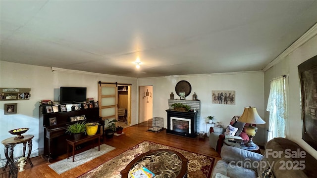 2118 Polkville Rd, Shelby, NC 28150 - living room featuring ornamental molding, a barn door, wood finished floors, and a fireplace