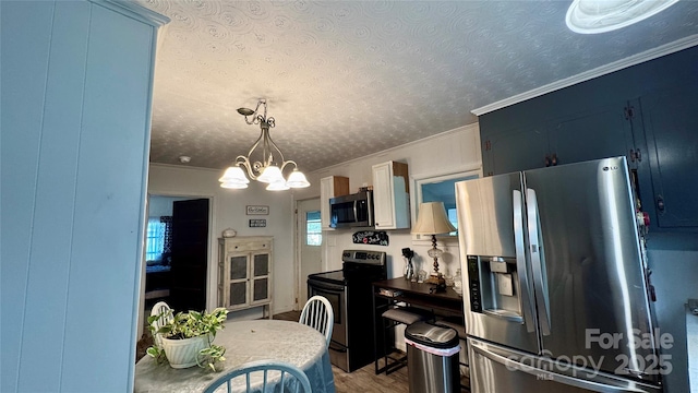 2118 Polkville Rd, Shelby, NC 28150 - kitchen featuring a textured ceiling, ornamental molding, a chandelier, appliances with stainless steel finishes, and wood finished floors