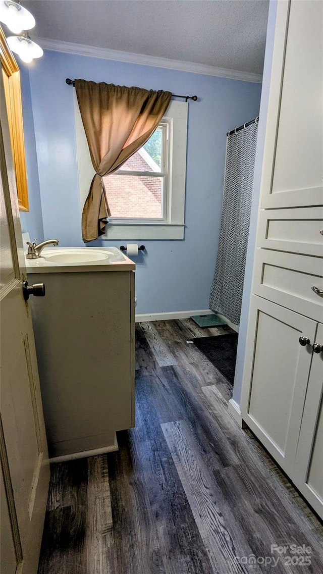 1306 Brantley Rd, Kannapolis, NC 28083 - bathroom with vanity, wood finished floors, crown molding, baseboards, and a shower with curtain