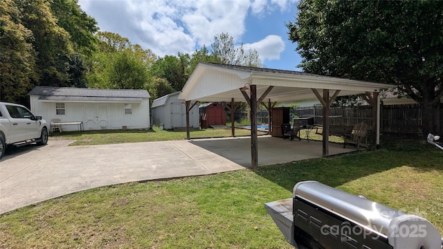 1306 Brantley Rd, Kannapolis, NC 28083 - view of vehicle parking with a storage unit, driveway, and a carport