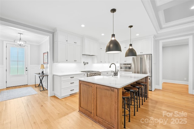 108 Castleview Ln, Mooresville, NC 28115 - kitchen featuring stainless steel appliances, light countertops, ornamental molding, a sink, and light wood-style flooring
