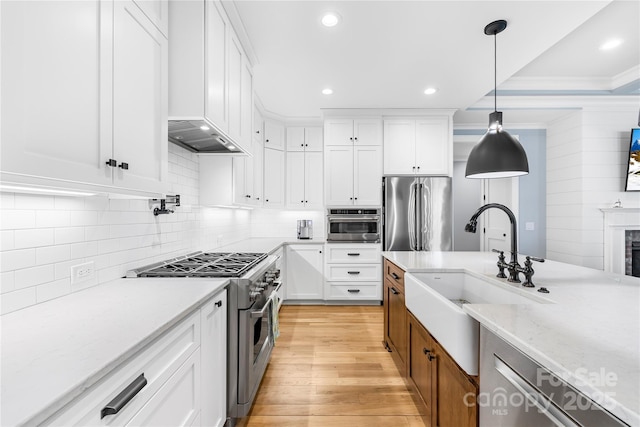108 Castleview Ln, Mooresville, NC 28115 - kitchen featuring a sink, light wood-type flooring, light stone countertops, pendant lighting, and appliances with stainless steel finishes