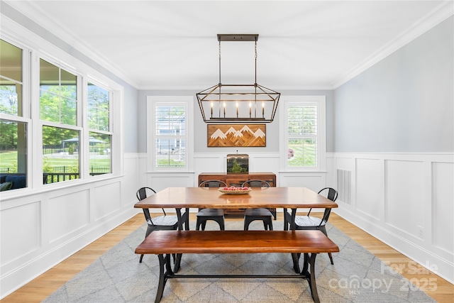 108 Castleview Ln, Mooresville, NC 28115 - dining space with wainscoting, a decorative wall, and crown molding