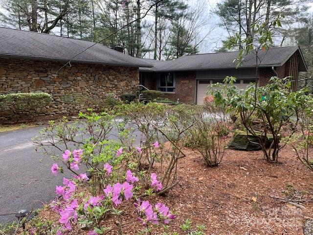 101 Lakemont Dr, Flat Rock, NC 28731 - view of front facade with stone siding, a garage, and a chimney