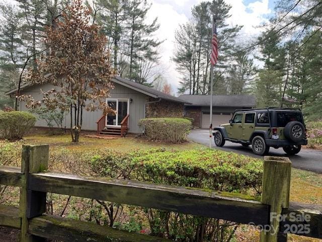 101 Lakemont Dr, Flat Rock, NC 28731 - view of front of house featuring entry steps, a garage, and aphalt driveway