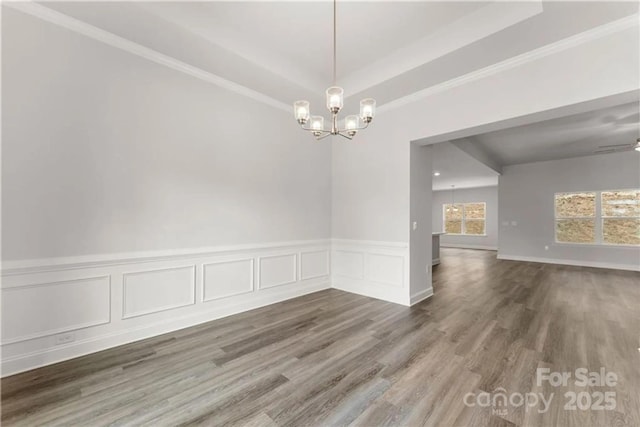 1469 Mocksville Hwy Unit 21, Statesville, NC 28625 - unfurnished room with a chandelier, wood finished floors, a wainscoted wall, crown molding, and a decorative wall